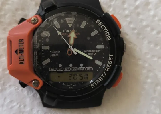 Reassembled Casio AW-330-AT in altimeter mode displaying 205 meters.